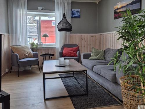 a living room with a couch and a coffee table at Apartment close to city center in Tromsø