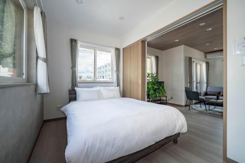 a bedroom with a white bed and a large window at MKS 101 - Vacation STAY 20131 in Gojōdōri