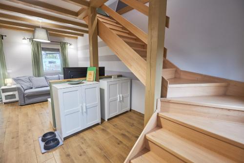 a room with stairs and a living room with a couch at Bodza apartman 2 - Sarud in Sarud