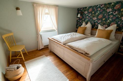 a bed in a room with a window and a bedroom at An der Linde in Sargstedt