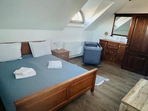a bedroom with a bed with two towels on it at Casa Hardic in Horodnic de Sus