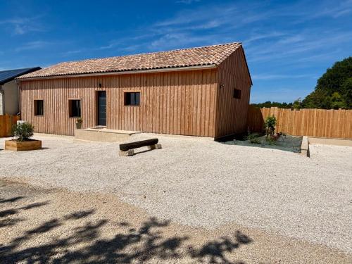 a wooden building with a bench in front of it at Vignes du Roc in Rayet