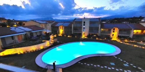 an overhead view of a swimming pool at night at New Apartment Lazise in Lazise