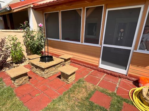 a patio with benches and a house with windows at Bodza apartman 2 - Sarud in Sarud