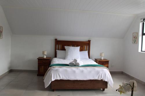 a bedroom with a bed with a stuffed animal on it at Forest Hideaway in Knysna
