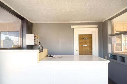 a kitchen with a white counter top in a room at Save Inn by Hotel O Forrest City AR HWY 70 in Forrest City