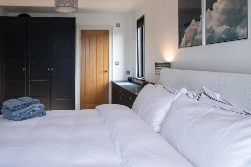 a bedroom with a large bed with white pillows at Trelawney in Yelverton