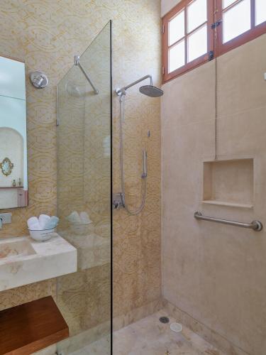 a bathroom with a shower and a sink at Casa Arabe - Yucatan Home Rentals in Mérida