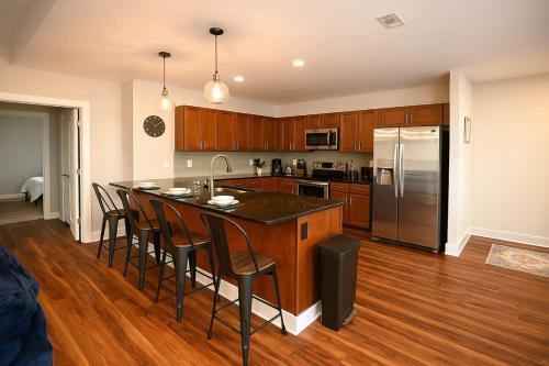 a kitchen with a large island with bar stools at Spacious Downtown Sq Stadium, Casino, R&R HoF! in Cleveland