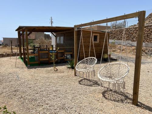 two swings in a yard next to a house at Finca La Suerte in Chimiche