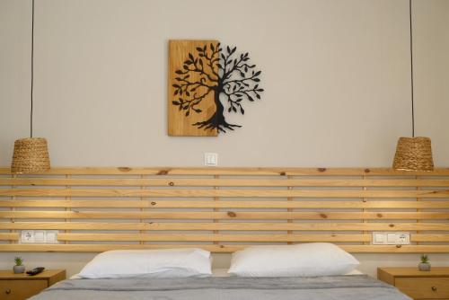 a bedroom with a tree picture on the wall at Cestrum Suites in Agios Nikolaos