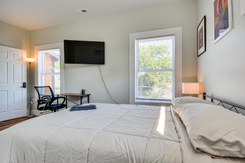 a bedroom with a bed and a flat screen tv at College Hub 1 Mi to Dtwn Greensboro Group Escape in Nocho Park