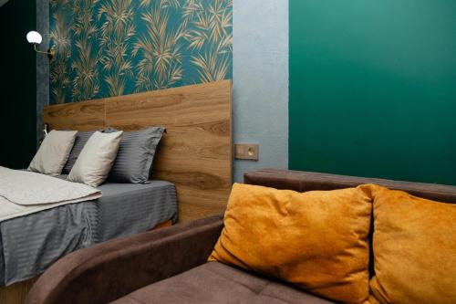 a living room with a couch and a bed at Hotel Graif Ti in Tbilisi City