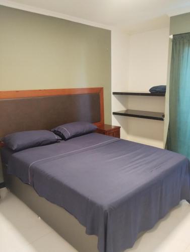a bedroom with a large bed with purple sheets at Eco paradise 226 in Cumbuco