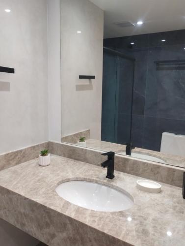 a bathroom counter with a sink and a shower at Eco paradise 226 in Cumbuco