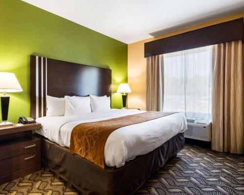 a hotel room with a large bed and a window at Baymont by Wyndham Jewett in Jewett
