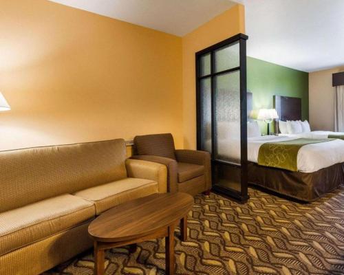 a hotel room with a couch and a bed at Baymont by Wyndham Jewett in Jewett