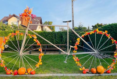 two large ferris wheel decorations with pumpkins on the grass at MoryńApartments R20 in Moryń