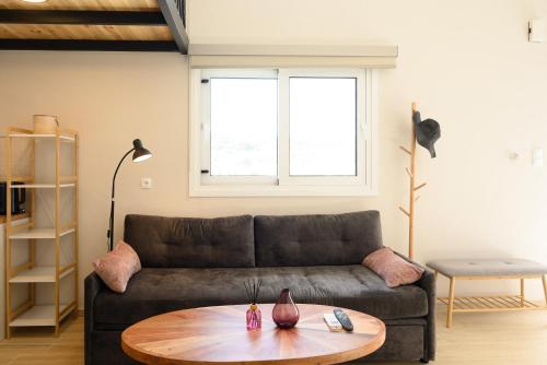 a living room with a couch and a table at Cestrum Suites in Agios Nikolaos