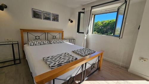 a bedroom with a large bed and a window at Villa Brač in Sumartin