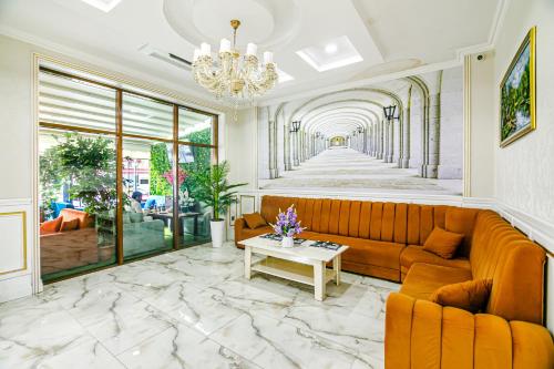 a living room with a couch and a table at Maris Hotel Baku in Baku