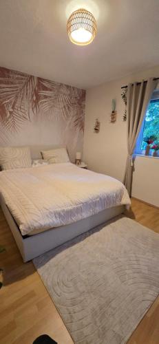 a bedroom with a large bed and a window at FeWo Oahu in Meisenheim