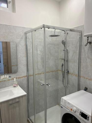a shower with a glass door in a bathroom at Mambo House in Milan