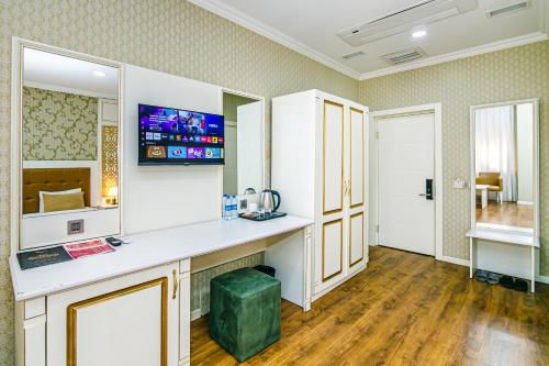 a room with a counter and a tv on the wall at Maris Hotel Baku in Baku