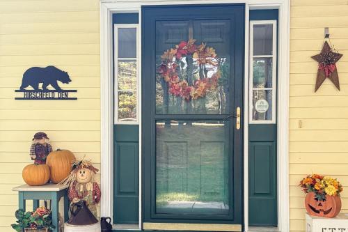 a front door of a house with a halloween decoration at White Mountain Getaway in Ossipee