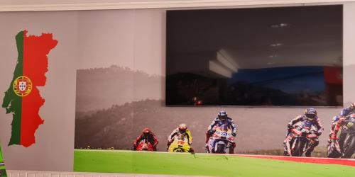 a wall with a picture of a group of people riding motorcycles at Hotel Luso Leixoes- in Bergondo