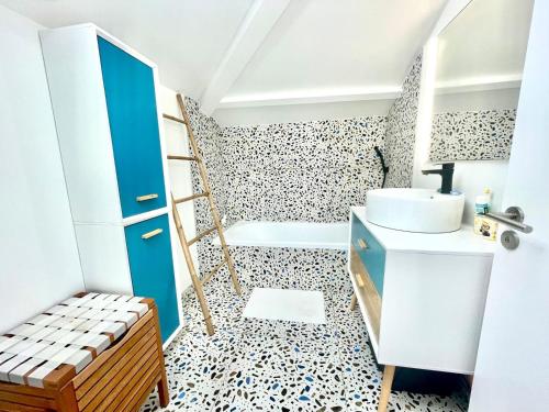 a bathroom with a blue cabinet and a sink at La Petite Cabine, 3chambres proche plage et centre in Les Sables-dʼOlonne