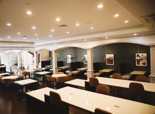 a restaurant with tables and chairs in a room at Wyndham Lake Charles in Lake Charles