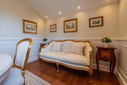 a living room with a white couch and a table at Villa do Vale Boutique Hotel in Blumenau