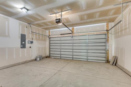 a garage with a garage door in a room at 3 Mi to Sand! Ocean Isle Beach Escape Near Golf in Seaside