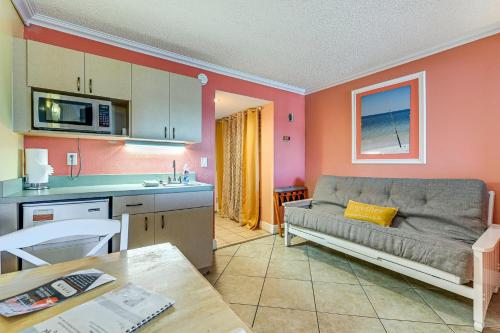 a living room with a couch and a kitchen at Pelican Point on Clearwater Beach in Clearwater Beach