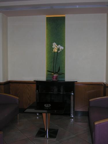 a vase with a flower on a table in a room at Espel in Andorra la Vella