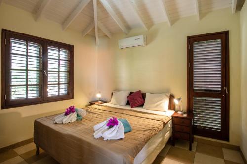 a bedroom with a bed with towels on it at Blue Bay Villa's in Blue Bay