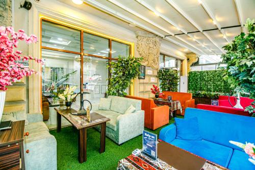 a living room with colorful furniture and plants at Maris Hotel Baku in Baku