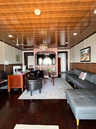 a living room with a couch and a table at The Ambassador's Terrace in Belize City