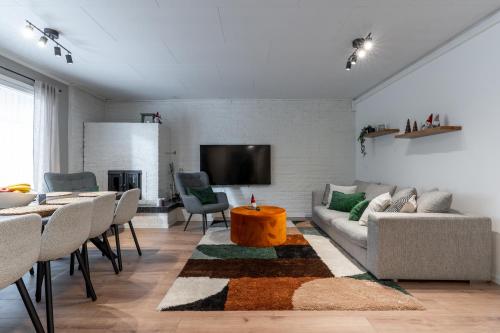 a living room with a couch and a table at Villa Santa's Star I near SCV in Rovaniemi