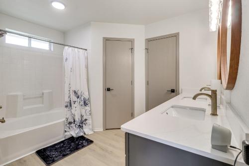 a white bathroom with a sink and a bath tub at Fenced-In Yard Family Home 4 Mi to Dtwn Killeen! in Killeen