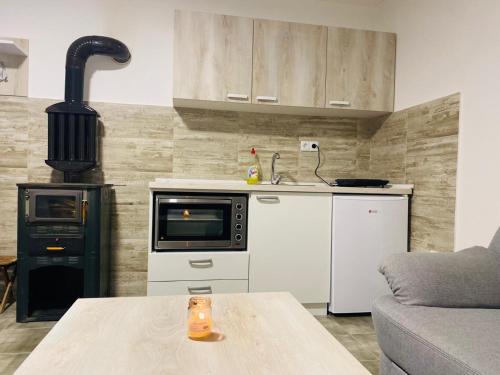 a kitchen with a stove and a table in a room at Vila Nina 
