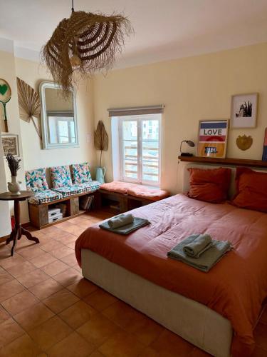 a bedroom with a large bed and a couch at Casa Paloma in Sanary-sur-Mer
