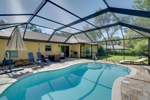 a swimming pool with a pergola over it at Private Heated Pool Sunny Homosassa Stay! in Homosassa