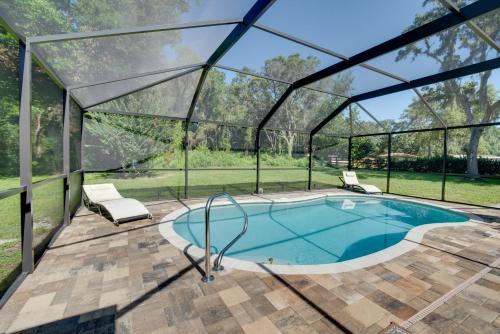 an indoor swimming pool in a glass house at Private Heated Pool Sunny Homosassa Stay! in Homosassa