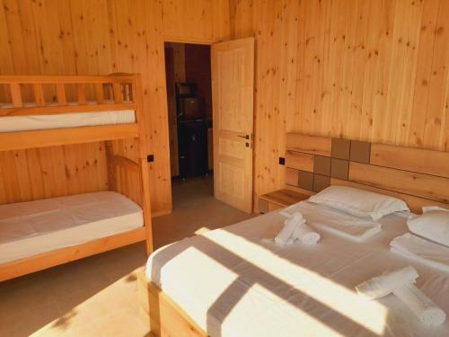a bedroom with two bunk beds in a wooden cabin at Jvarisa Winery 