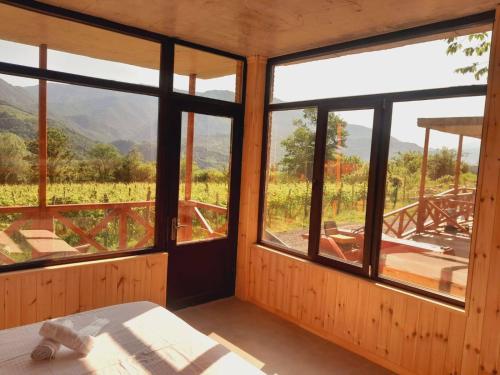 a bedroom with windows and a view of a mountain at Jvarisa Winery 