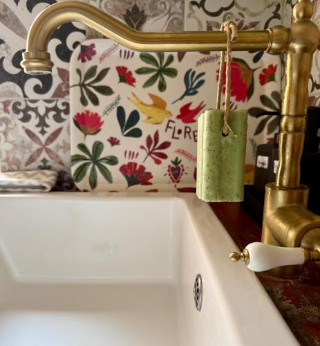 a bathroom sink with a candle hanging from a faucet at Casa Paloma in Sanary-sur-Mer