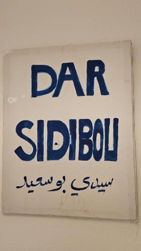 a sign for a saudi shop in a wall at Dar Sidi Bou in Tozeur