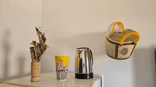 a table with a coffee maker and a basket at Dar Sidi Bou in Tozeur